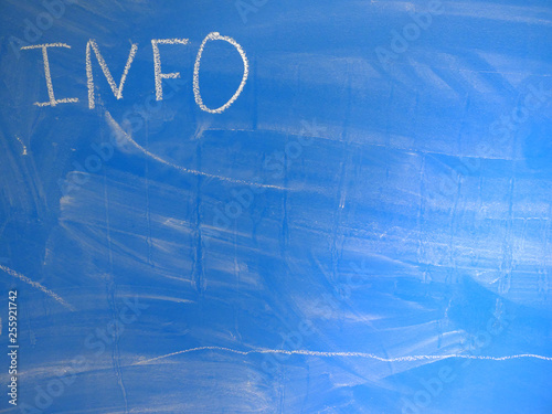 Abbreviation INFO written on a blue, relatively dirty chalkboard by chalk. Located in the upper left corner of the image making space for some message or note on the board.