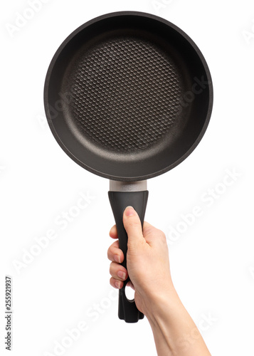 Female hand holding simple new empty Non-stick Frying Pan with black handle, isolated on white background.