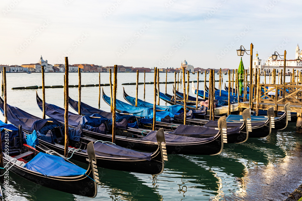 Empty gondolas floating on a lagoon of Venice, Italy