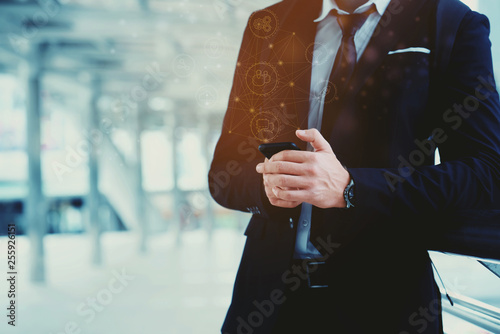 Caucasian Businessmen are standing in city Hand holding a smartphone 5G network to communicate with people in digital business online Internet technology in everything Making work orders from anywhere