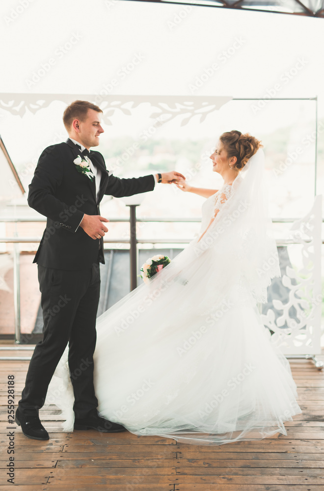 Beautiful bride and groom spinning with perfect dress