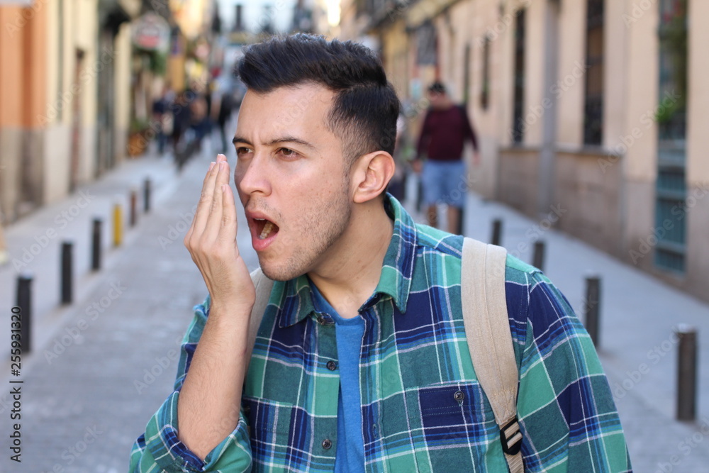 Man checking his own breath Man checking his own breath