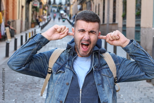 Pedestrian annoyed with the urban noise