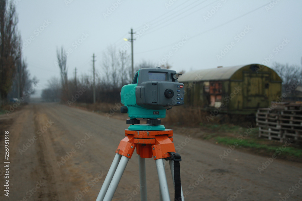 Digital level on the tripod. Leveling, geodetic works Digital level on the tripod. Leveling, geodetic works