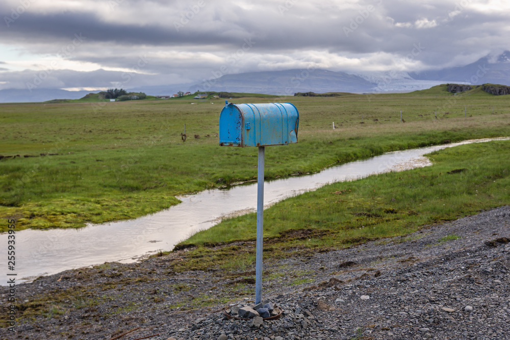 Blue rusty mail box next to gravel road in southeastern part of Iceland Blue rusty mail box next to gravel road in southeastern part of Iceland