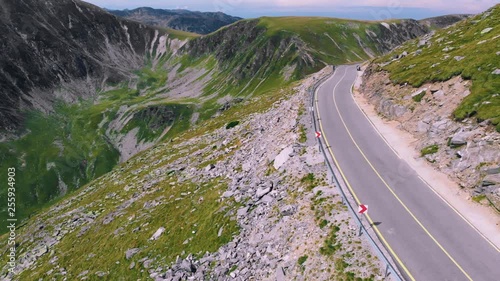 Aerial winding road with incredibly beautiful views on Transalpina, cars and motorcyclists on road. Romania mountain, travel, adventure concept, motorcyclists way, vacation place, mountains top Europe