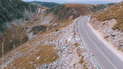 Aerial winding road with incredibly beautiful views on Transalpina, cars and motorcyclists on road. Romania mountain, travel, adventure concept, motorcyclists way, vacation place, mountains top Europe