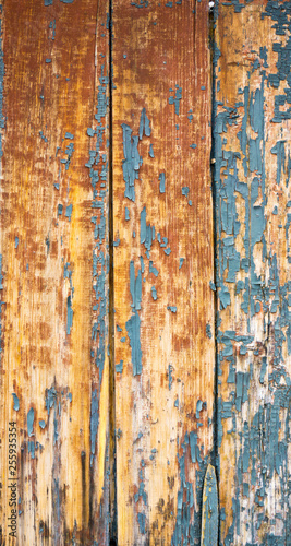 old wooden fence with cracked blue paint