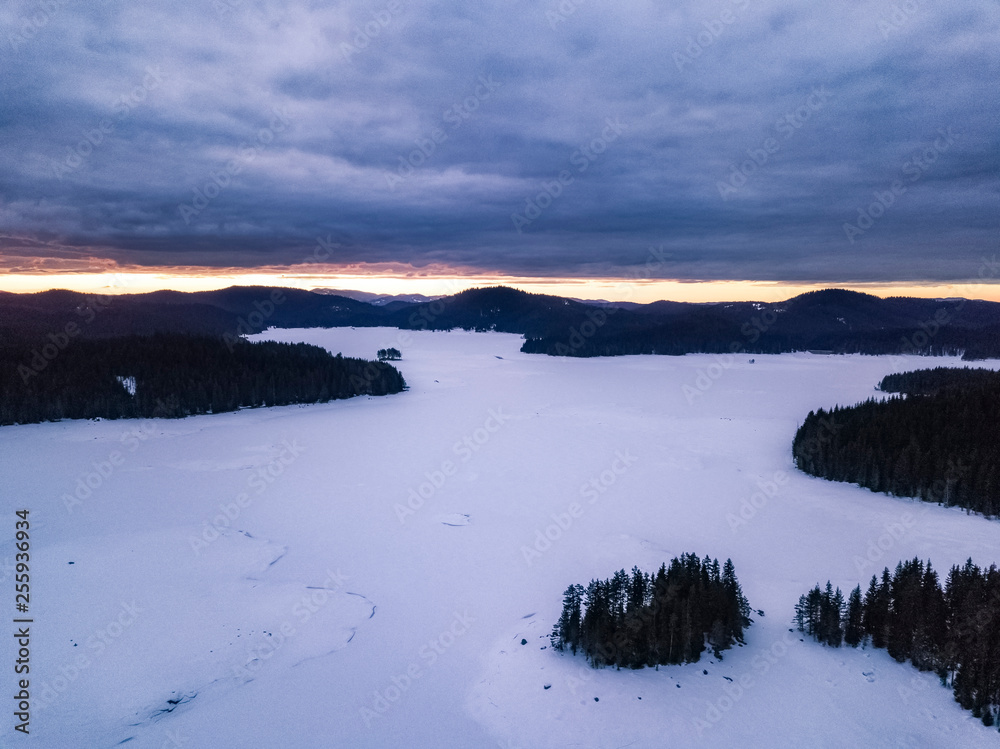 Winter landscape aerial drone panoramic photo over Shiroka poliana lake in Rhodope mountain, Bulgaria