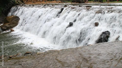 The water flows through the rocks.
