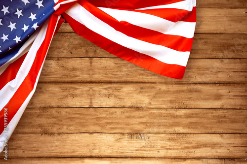Fototapeta Naklejka Na Ścianę i Meble -  USA Flag folded with wooden background