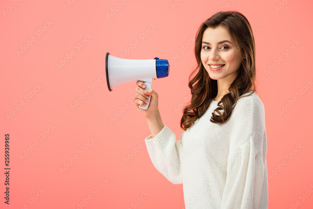 brunette woman in white sweater holding megaphone isolated on pink brunette woman in white sweater holding megaphone isolated on pink