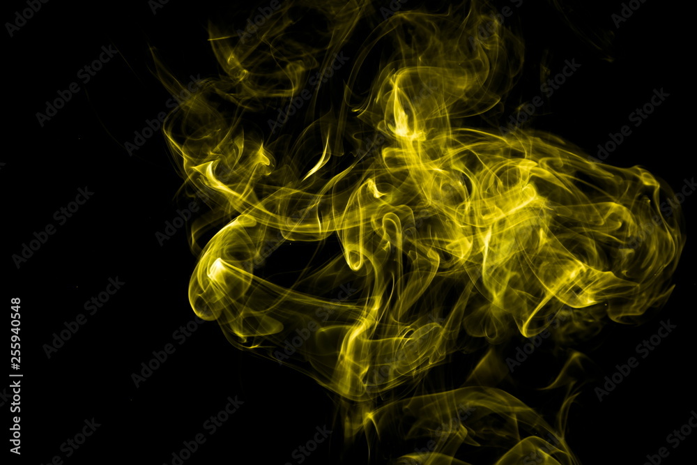 Fototapeta premium Yellow smoke on black background