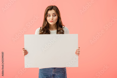 beautiful woman holding empty board with copy space isolated on pink