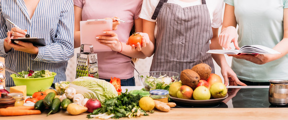 Cooking classes. Food preparing hobby. Group of women learning healthy eating lifestyle and balanced nutrition.