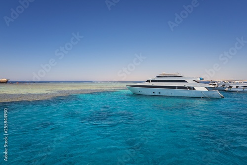 Luxury yacht docking near coral reef