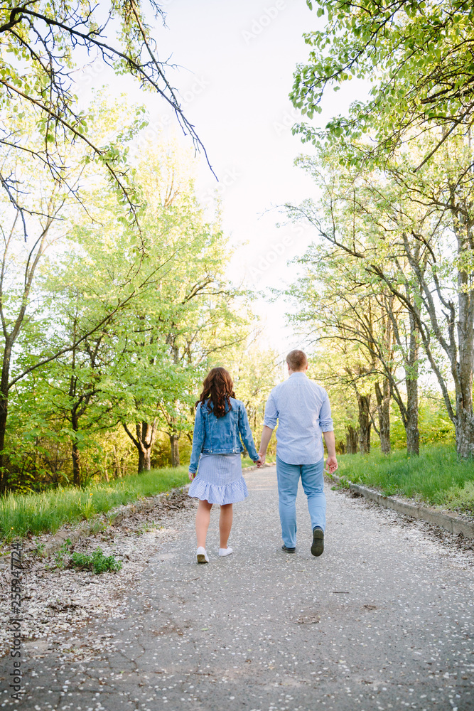 young couple walking in the park young couple walking in the park