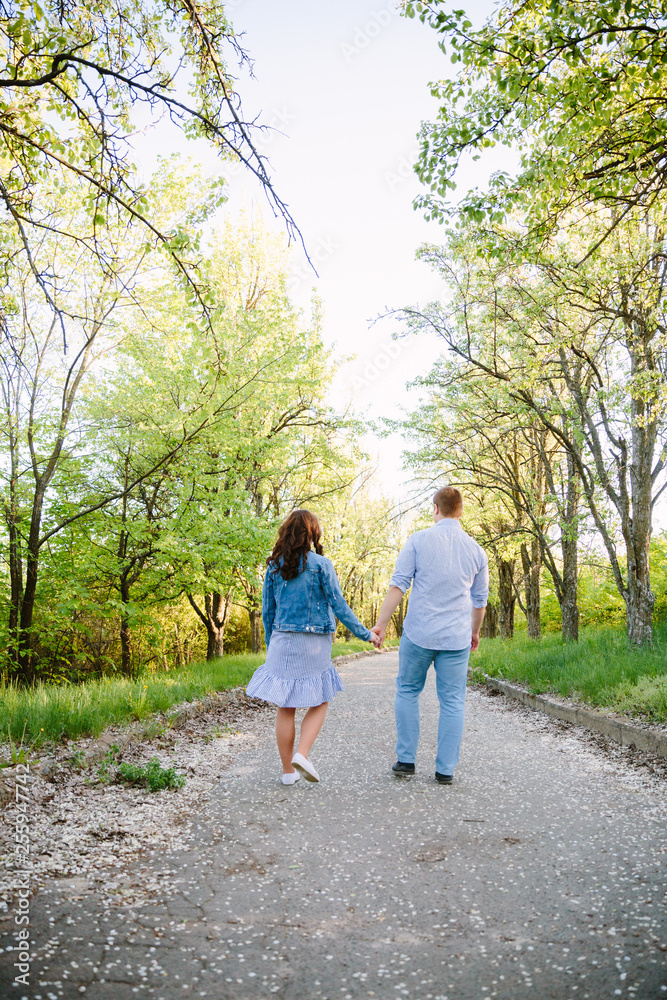 young couple walking in the park young couple walking in the park