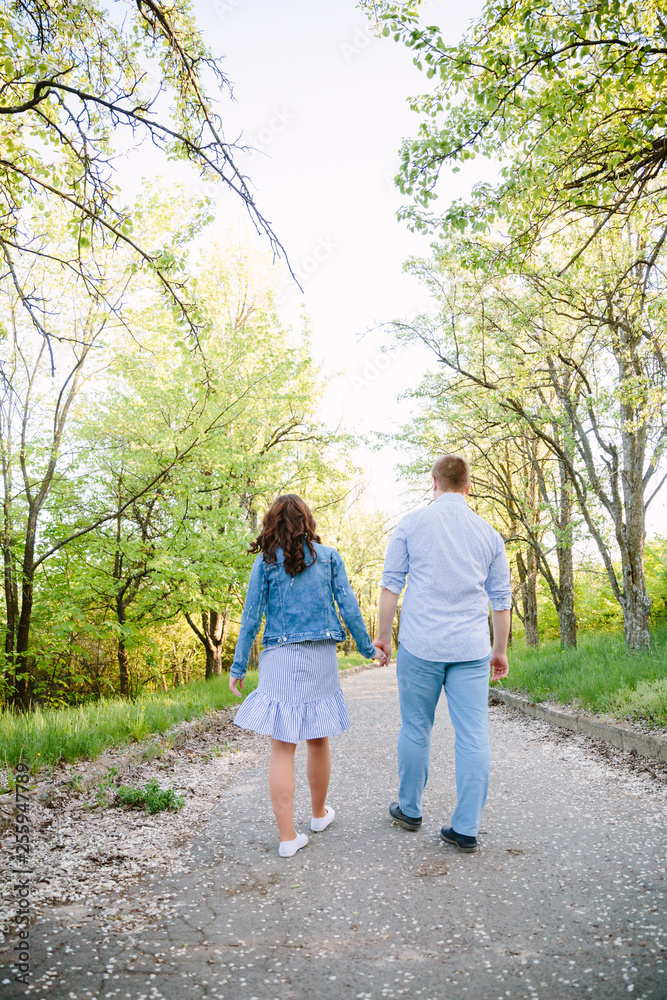 young couple walking in the park young couple walking in the park