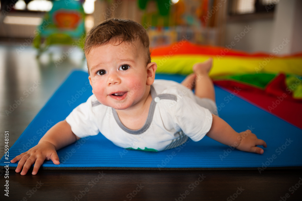 Little baby boy playing in living room on the floor Little baby boy playing in living room on the floor