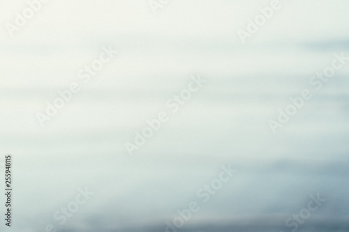 Blur beach with couple relaxation with sun light and blue sky.