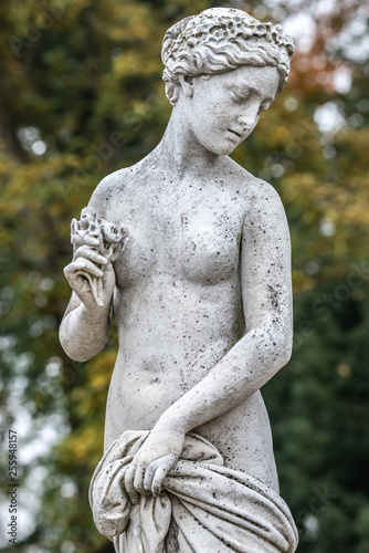Statue of sensual naked Greek renaissance era woman with flowers, Potsdam, Germany, details, closeup
