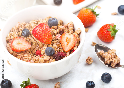 Bowl of healthy cereal granola with strawberries