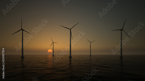 Wind turbines on the rising sun background 