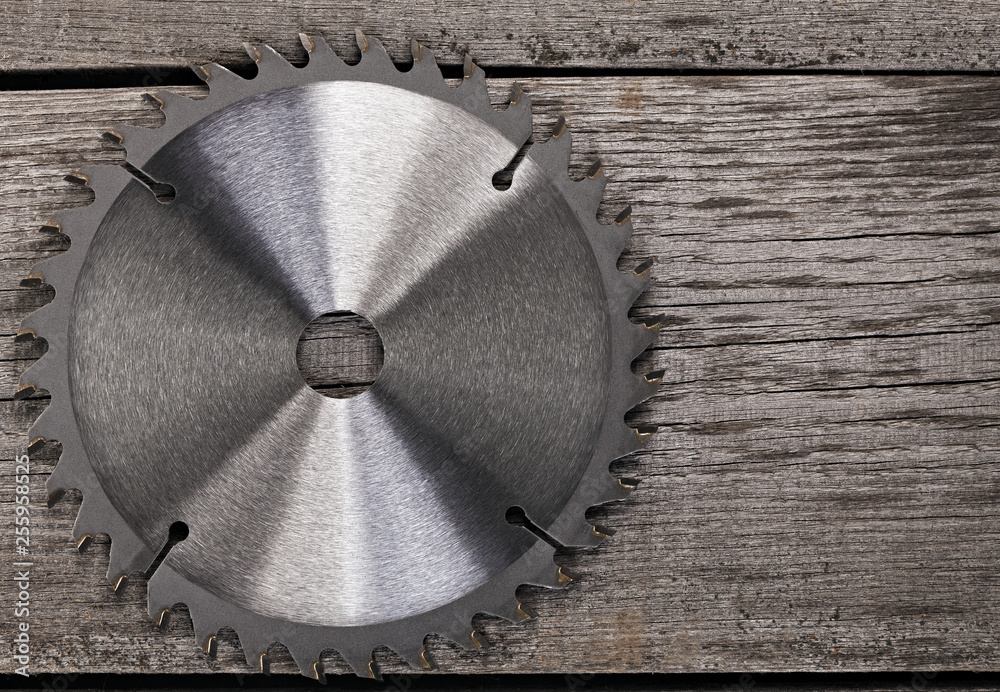 Circular saw on wooden background