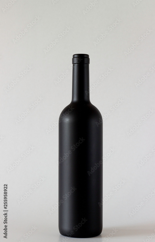Wine black bottle are standing on gray background
