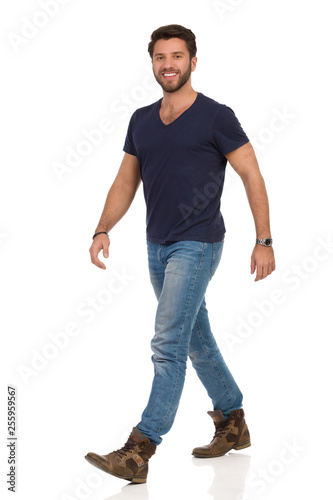 Happy Walking Man In Blue T-shirt, Jeans And Boots