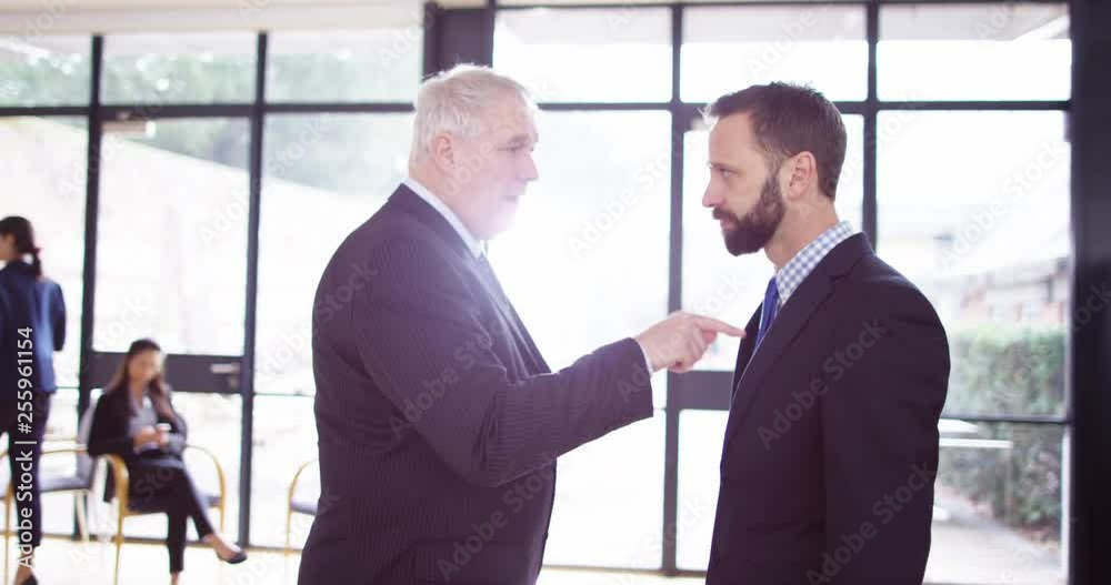 4K Mature businessman being aggressive & confrontational with younger colleague 4K Mature businessman being aggressive & confrontational with younger colleague