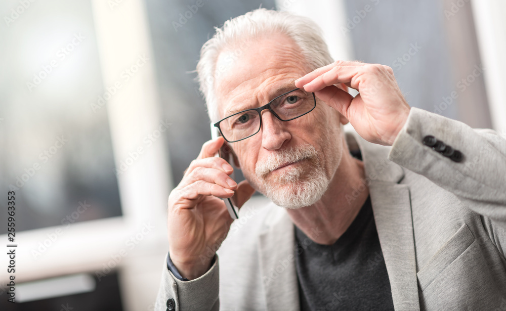 Portrait of mature businessman using mobile phone Portrait of mature businessman using mobile phone
