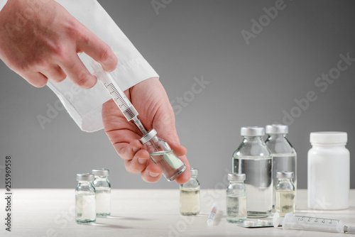 Physician filling a syringe