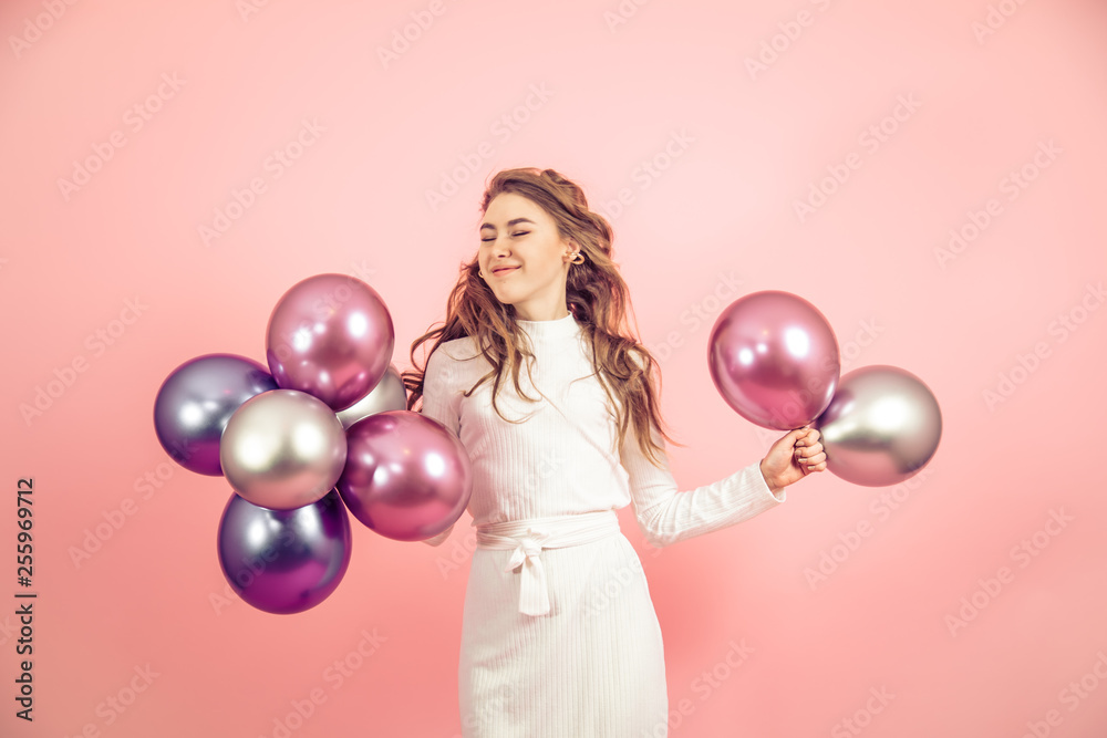 Fototapeta premium Young girl with balls on a colored background