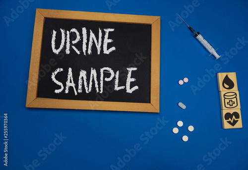 wooden tablet on blue medical table with the word URINE SAMPLE