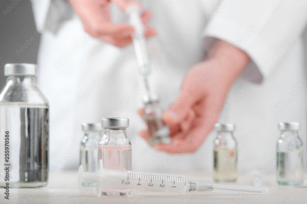 Syringe and vials on desk Syringe and vials on desk