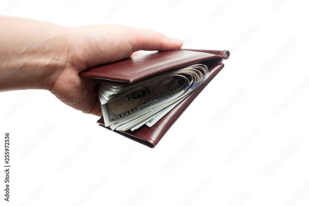 A hand holding a wallet full of new one hundred dollar bills isolated over a white background. Copy space A hand holding a wallet full of new one hundred dollar bills isolated over a white background. Copy space