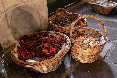 Baskets with dried aliments inside like dried tomatoes  mushrooms  raisins and roots