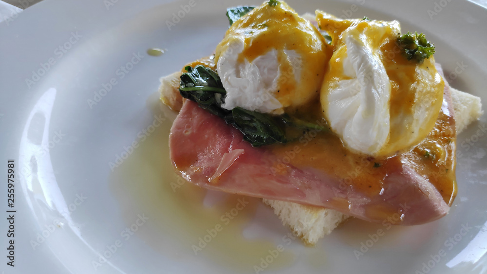 Eggs Benedict and toasted bread with spinach Eggs Benedict and toasted bread with spinach