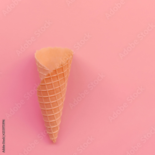 Cone for ice cream on a coral background. Empty cone for ice cream with a place for copy-paste.