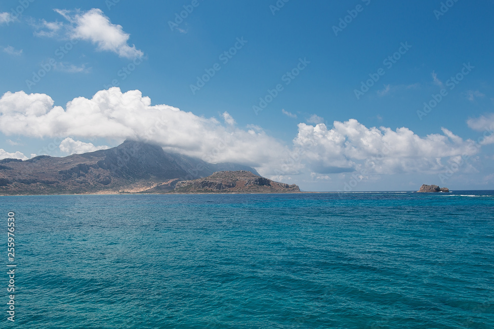 View of the coast. Sea. Mountains. Rocks. Clouds.