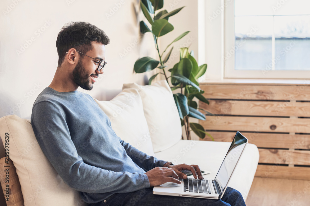 Handsome young man using laptop computer at home. Student men resting in  his room. Home work or study, freelance concept Stock Photo | Adobe Stock