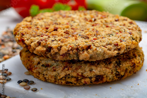 Tasty vegetarian food, raw burgers made from lentils legumes with vegetables ready for cooking