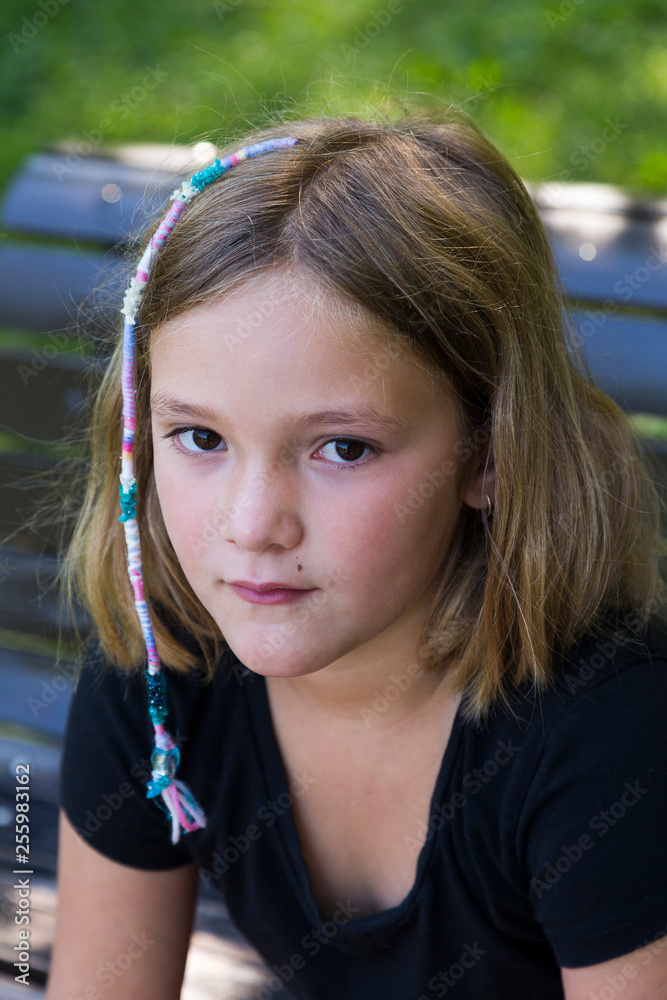 Close up of pretty little girl in black shirt with hippie style cotton hair  braid Stock Photo | Adobe Stock