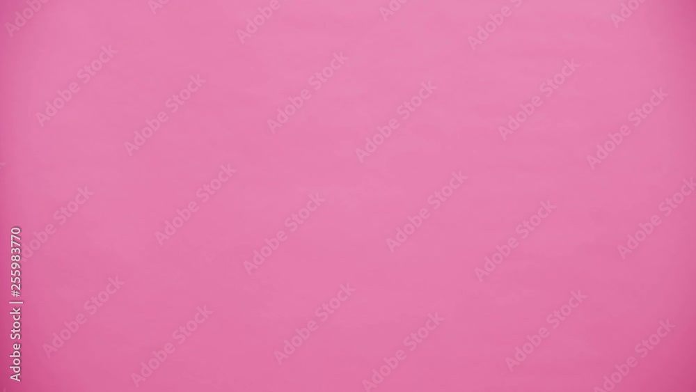 Young lovers show up on the pink background gently hugging. A man holding a carcass takes her for a cigarette. With the ears of a pink rabbit on the head. Easter concept. Young lovers show up on the pink background gently hugging. A man holding a carcass takes her for a cigarette. With the ears of a pink rabbit on the head. Easter concept.