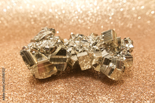 The pyrite crystal on golden background