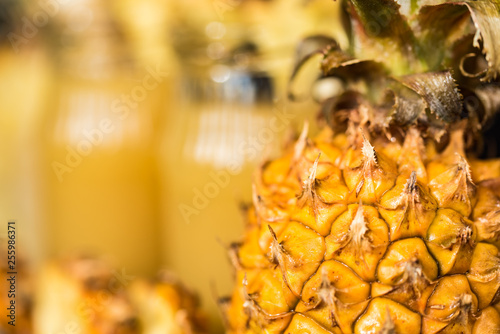 Pineapple juice and slice placed on a wooden table photo