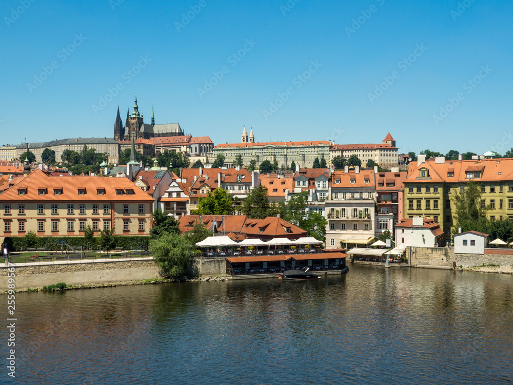 Scenic view on Vltava river and historical center of Prague, buildings and landmarks of old town at sunset, Prague, Czech Republic. August, 2018