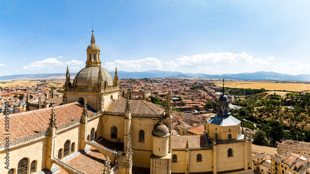 Segovia, Spain – Panoramic 16:9 view of the dome of the Cathedral and of Segovia old town from the top of the bell tower during Summer time. The peaks of Sierra de Guadarrama are visible behind